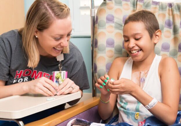 Child Life Specialist with Cardinal Glennon patient in The Costas Center