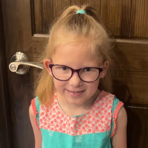 Kenzie - smiling at home in front of door