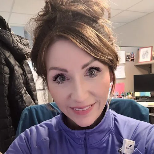 Selfie style photo of Beth Hill at her desk in Cardinal Glennon